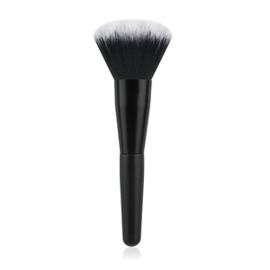 Macro view of flame-shaped makeup brush with black and white gradient soft bristles