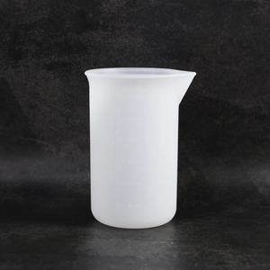 Close-up of 120ml silicone measuring cup with clear scale marks and pouring spout