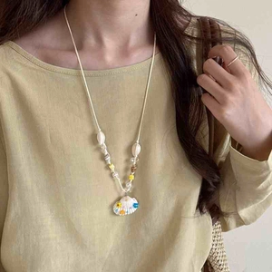 Bohemian wax rope necklace featuring hand-painted shell pendant and colorful summer beads