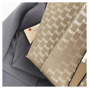 Detailed macro view of the jacquard canvas texture with letter logo on tote bag