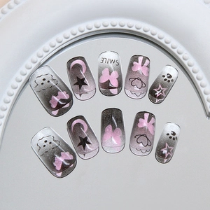 Cat eye press-on nails with celestial star moon motifs and cute hand-painted puppy patterns