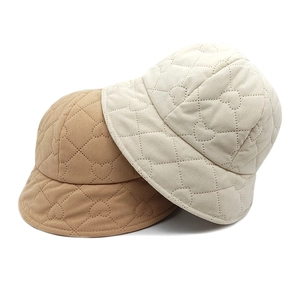Vintage corduroy bucket hats with quilted heart pattern in beige and caramel brown colors
