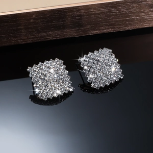Macro detail of silver square stud earrings featuring micro-pave crystal rhinestones