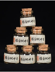 Macro shot of traditional handmade incense pills in glass jars with cork lids