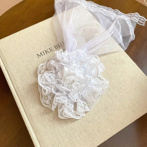 Detail of white Lolita lace veil featuring satin rose petals and delicate mesh ruffles