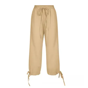 Detail of cotton linen wide-leg pants featuring drawstring waist and adjustable ankle ties