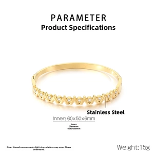 Macro shot of gold-plated bangle showing V-shape geometry and measurements 60x50x6mm
