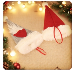Christmas silverware holder with forest gnome hats on rustic fabric with festive pine and bokeh lights