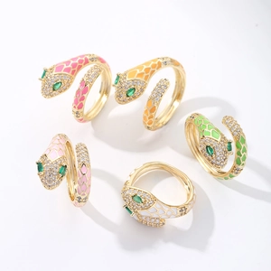 Macro view of five colorful enamel snake rings with sparkling crystals and adjustable bands