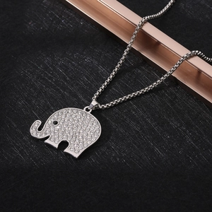 Macro shot of silver elephant pendant with sparkling rhinestones on a box chain link