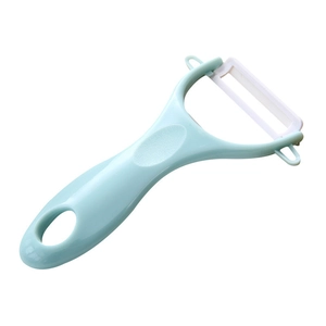 Light blue ceramic peeler with ergonomic handle and white blade for kitchen vegetables