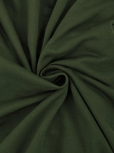 Close-up of dark green knitted fabric texture showing soft breathable weave detail