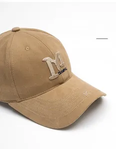 Close-up of khaki baseball cap with 3D M embroidery and adjustable curved wide brim