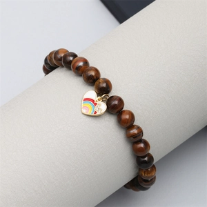 Natural tiger eye stone beaded bracelet with rainbow heart pendant on display stand