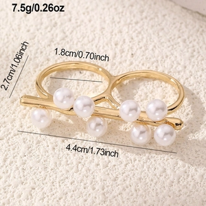 Detail view of a gold double-finger ring with eight pearls, including size and weight specs