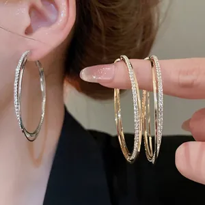 Double-layered pave rhinestone hoop earrings in gold and silver finish for women