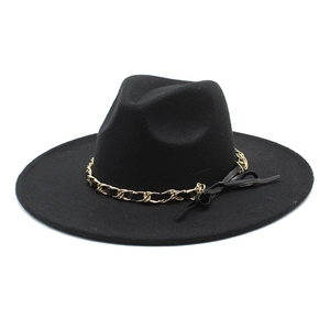 Close-up of wide brim wool fedora with gold chain and black leather bow detail