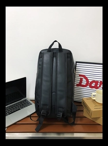 Detail of ergonomic S-shaped shoulder straps on a black water-resistant backpack