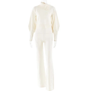 Detail view of cream knit set featuring lantern sleeves and ribbed cuffs on the sweater