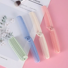 Detailed view of portable folding hair combs in various pastel colors on a pink background.