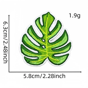 Detailed monstera leaf embroidery patch showing 6.3cm x 5.8cm size and green thread texture