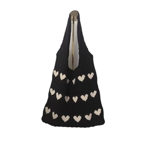 Casual black knitted shoulder bag with white heart patterns and integrated handle