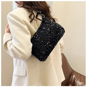Detail of black sequin shoulder bag showing textured shimmer and knotted leather strap