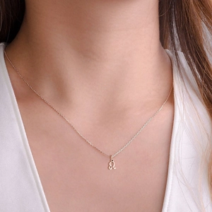 Close-up of rose gold Leo zodiac pendant necklace on a minimalist link chain