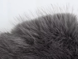 Close-up detail of soft grey faux fur texture showing fluffy and premium material quality