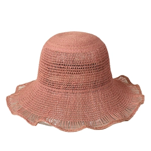 Pink raffia sun hat for women featuring a wide wavy brim and breathable straw weaving
