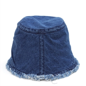 Close-up of distressed denim bucket hat edges showing raw fringe detail and fabric texture