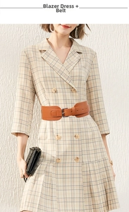 Detail of a brown wide waist belt with a metal buckle worn over a plaid blazer dress