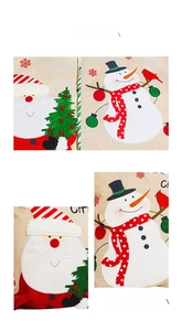 Detalle de funda de cojín navideña en lino con estampados de Papá Noel y Muñeco de nieve