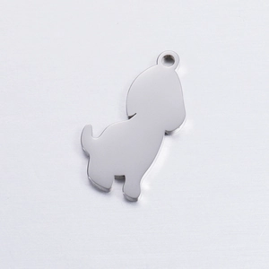 Macro shot of silver stainless steel dog pendant with smooth mirror finish and hanging hole