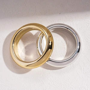Minimalist geometric round metal bangles in polished gold and silver finish