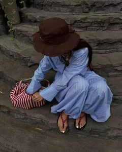 Detailed view of light blue striped lounge set with wide-leg pants and matching shirt