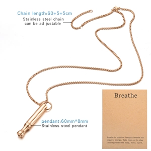 Macro view of rose gold mindfulness whistle pendant with adjustable steel chain