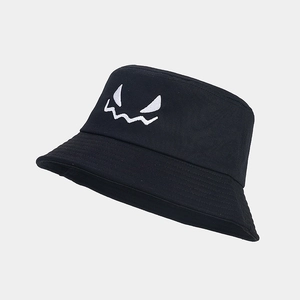 Close-up of white ghost face embroidery on black cotton Halloween bucket hat