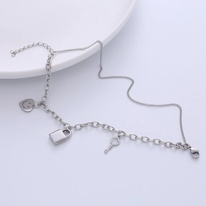 Hip hop titanium steel chain bracelet featuring heart smile, lock and key charms