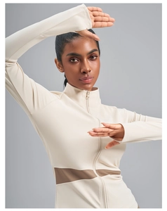 Detail of beige slim-fit zip-up sports jacket with brown mesh splicing and thumb holes