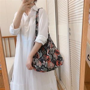 Mirror selfie showing the fit of a large floral cotton tote bag with vintage rose print