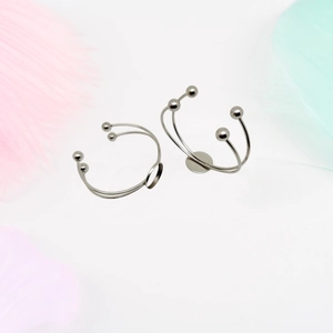 Detail view of double-layer stainless steel C-shaped cuff bracelets with blank round bezels