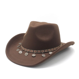 Brown western cowboy hat with ethnic woven band and silver coin pendants on white background