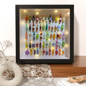 3D shadow box frame with black finish featuring mini liquor bottles and warm LED lights