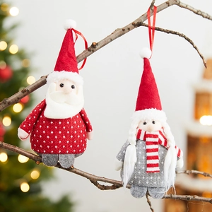 Christmas plush ornaments with Santa and snowman figurines hanging on branches
