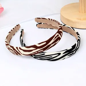 Retro animal print padded headbands in brown and black zebra stripes with non-slip lining