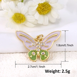 Detailed macro view showing dimensions and weight of gold butterfly charm with enamel wings
