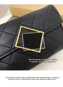 Close-up of black quilted leather bag featuring a gold square lock and chain detail