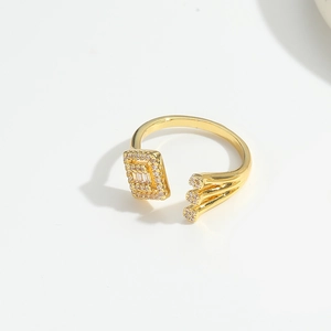 Macro detail of golden open ring featuring rectangular pavé zircon and triple row crystal studs