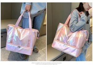 Pink holographic travel bag shown by model featuring large capacity and shoe compartment